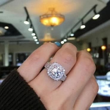 Elegantni damski prsten sa centralnim okruglim kamenom i duplim halo
