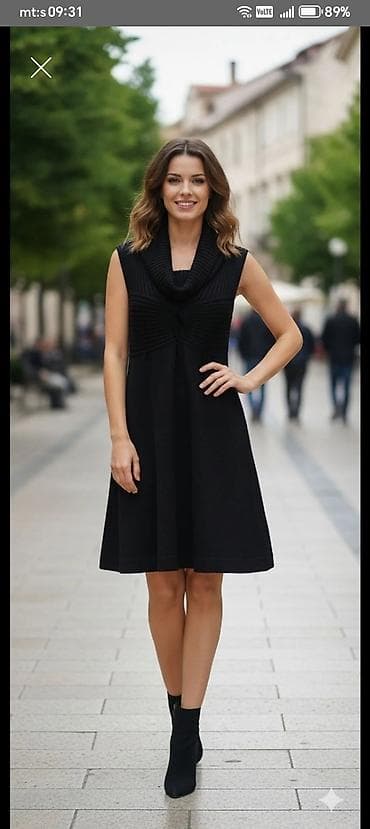 Crna haljina bez rukava, A-kroja, dužine do kolena. Gornji deo izrađen — 1