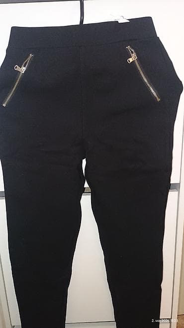 nike biciklisticke: Crne ženske pantalone sa elastičnim strukom i uskim nogavicama. Model — 2