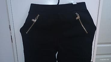 nike biciklisticke: Crne ženske pantalone sa elastičnim strukom i uskim nogavicama. Model — 4