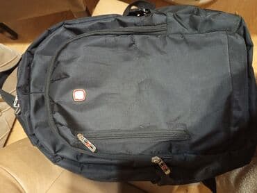 Trotineti, skejtbordovi i hoverbordovi: Crni ranac. Made in Swiss ojacan. Nеma ostecenja .Duzina 50cm,sirina — 10