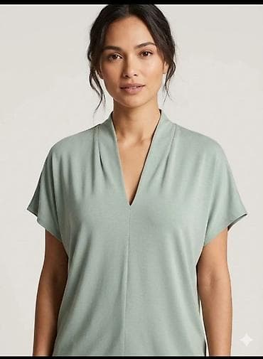 Ženska bluzica sa V-izrezom, pastelno zelene boje. Model sa opuštenim