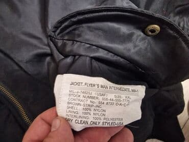 new yorker crna gora online: Crna bomber jakna (MA-1 stil) sa narandžastom postavom. - Materijal — 5