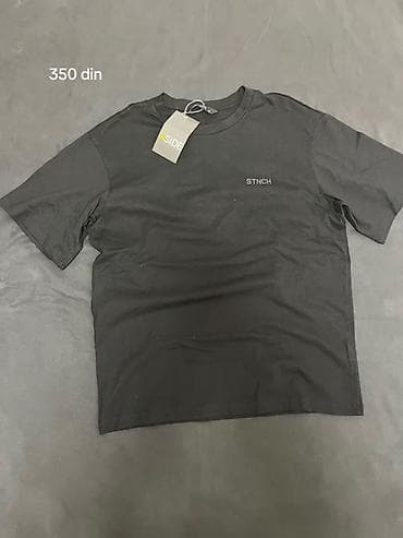 Crna majica kratkih rukava sa diskretnim natpisom “STNCH” na levoj