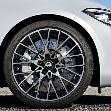 20555 r16 felni: Čepovi za felne NISSAN - set 4 komada Čepovi za felne sa logom NISSAN — 4