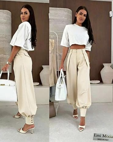 straus pantalone: Ženske elegantne pantalone sa spuštenim krojem i manžetnama - Model — 1