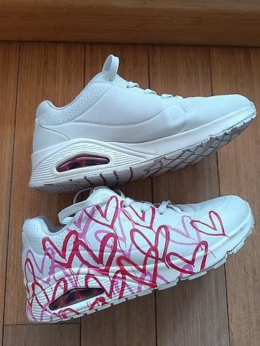 tereks patike planeta: Par belih Skechers patika, jedan par je potpuno beo, dok je drugi — 1