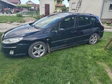 lidl presvlake za auto: Peugeot 407 SW karavan u crnoj boji. Vozilo ima krovne nosače i alu — 2