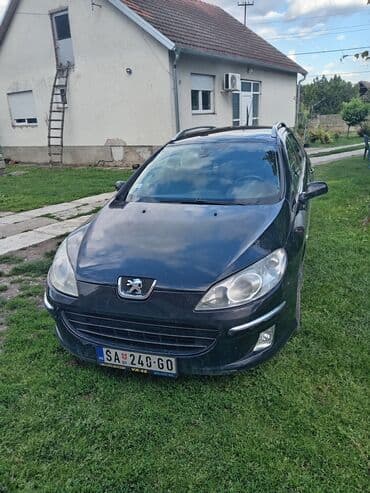 lidl presvlake za auto: Peugeot 407 SW karavan u crnoj boji. Vozilo ima krovne nosače i alu — 1