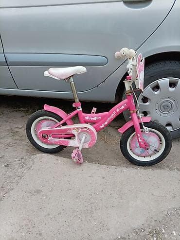 Dečiji bicikl za devojčice, ružičaste boje sa motivima srca/krunica. -