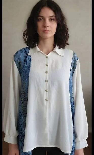 Ženska košulja sa dugim rukavima i klasičnim kragnom. Prednji deo se