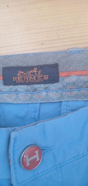 torbica kozna oficirska: Hermès muške pantalone – model chino, svetloplave boje. - Brend — 1