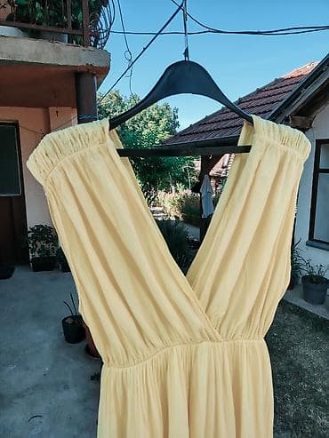 opise: Ženska midi haljina u žutoj boji, laganog i lepršavog kroja. Model — 7