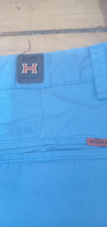 torbica kozna oficirska: Hermès muške pantalone – model chino, svetloplave boje. - Brend — 2