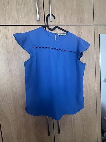 vunene pantalone zenske: Plava ženska bluza bez rukava, nežno talasastih kratkih rukavića — 1