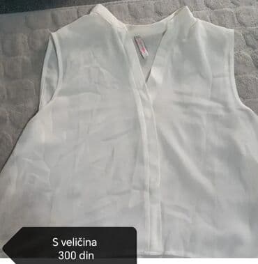 set za nokte za devojcice: Bela bluza bez rukava, idealna za kombinovanje u različitim stilovima — 1