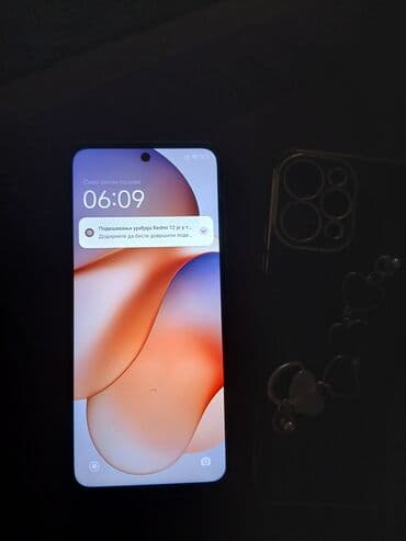 mp3 za auto: Redmi 12 telefon, crne boje, sa pratećom futrolom. Telefon ima ekran — 2