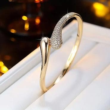 bez ranac: Elegantna ženska narukvica – zlatni ton, otvoreni dizajn sa kapljastim — 1