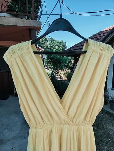 opise: Ženska midi haljina u žutoj boji, laganog i lepršavog kroja. Model — 6