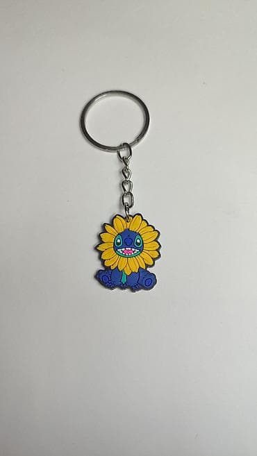 Privesak za ključeve – lik plavog čudovišta sa žutim cvetnim krunom