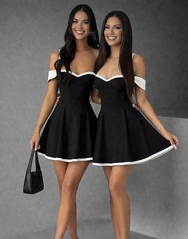 Crna mini haljina sa belim porubom, dizajnirana sa spuštenim ramenima