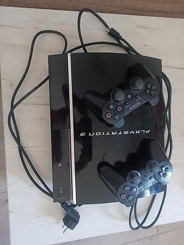 video igrice stare: PlayStation 3 Slim konzola crne boje, opremljena sa dva kontrolera — 1