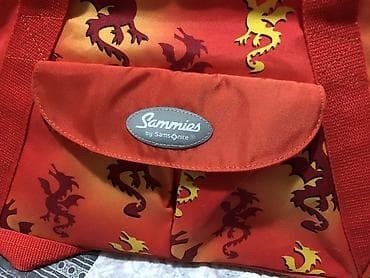 Samsonite dečija putna torba na rame pretežno narandžaste boje sa