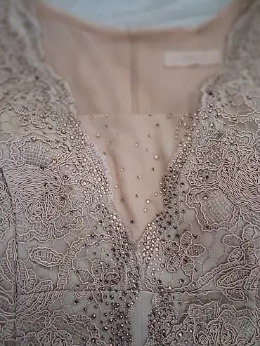 Elegantna haljina od čipke sa ručno našivenim perlicama i štrasom. -