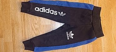 Crne dečije pantalone "Adidas" sa plavim bočnim trakama i belim na lalafo.rs — 1 Crne dečije pantalone "Adidas" sa plavim bočnim trakama i belim — 1