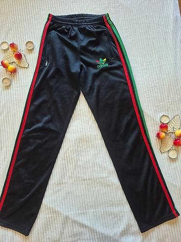 Crne sportske trenerke sa prugama u bojama žuto–zeleno–crveno duž at lalafo.rs — 1 Crne sportske trenerke sa prugama u bojama žuto–zeleno–crveno duž — 1