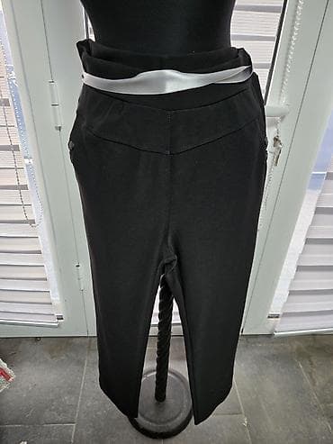 Crne ženske pantalone sa uskim nogavicama. Visok struk sa dekorativnim na lalafo.rs Crne ženske pantalone sa uskim nogavicama. Visok struk sa dekorativnim