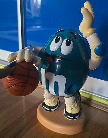 MM - M&M bonbone se ubace, i kad se povuce ruka ispadaju. Igracka na lalafo.rs — 2 MM - M&M bonbone se ubace, i kad se povuce ruka ispadaju. Igracka — 2