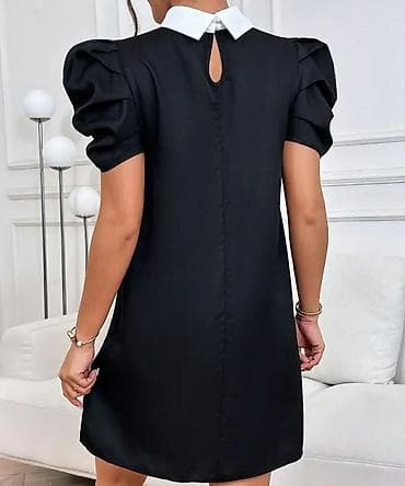 Crna mini haljina A-kroja sa ukrasnim bisernim perlama. Model ima na lalafo.rs Crna mini haljina A-kroja sa ukrasnim bisernim perlama. Model ima