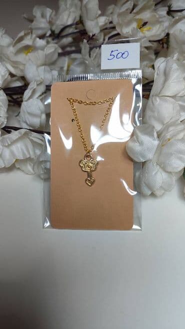 Zlatno-tonirani set ogrlice sa klasičnim lancem i privjeskom u obliku na lalafo.rs Zlatno-tonirani set ogrlice sa klasičnim lancem i privjeskom u obliku