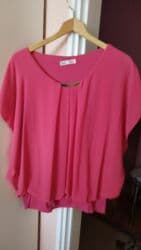 Elegantna ženska bluza u jarko roze boji. - Kroj: ležeran, sa blagim na lalafo.rs Elegantna ženska bluza u jarko roze boji. - Kroj: ležeran, sa blagim